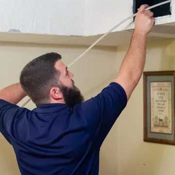 Air duct vent being cleaned