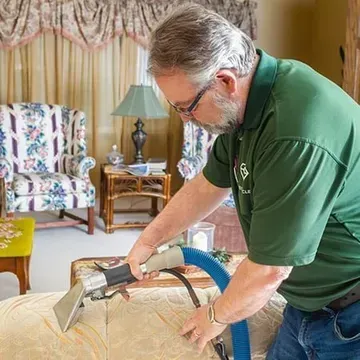 Upholstered sofa being professionally cleaned